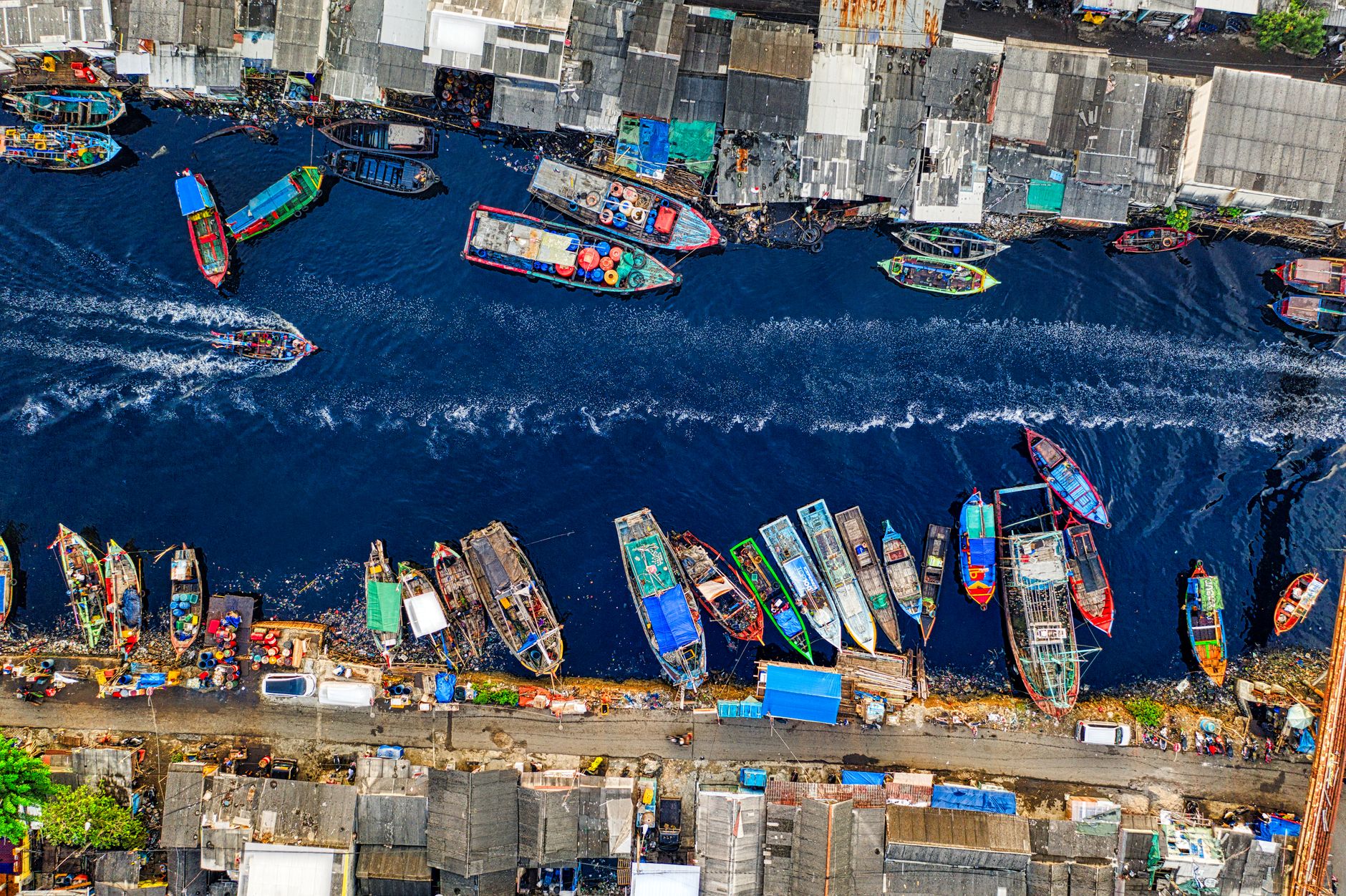 aerial footage of boats docked on a riverside